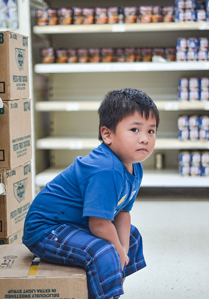 Boy seated in Food Bank